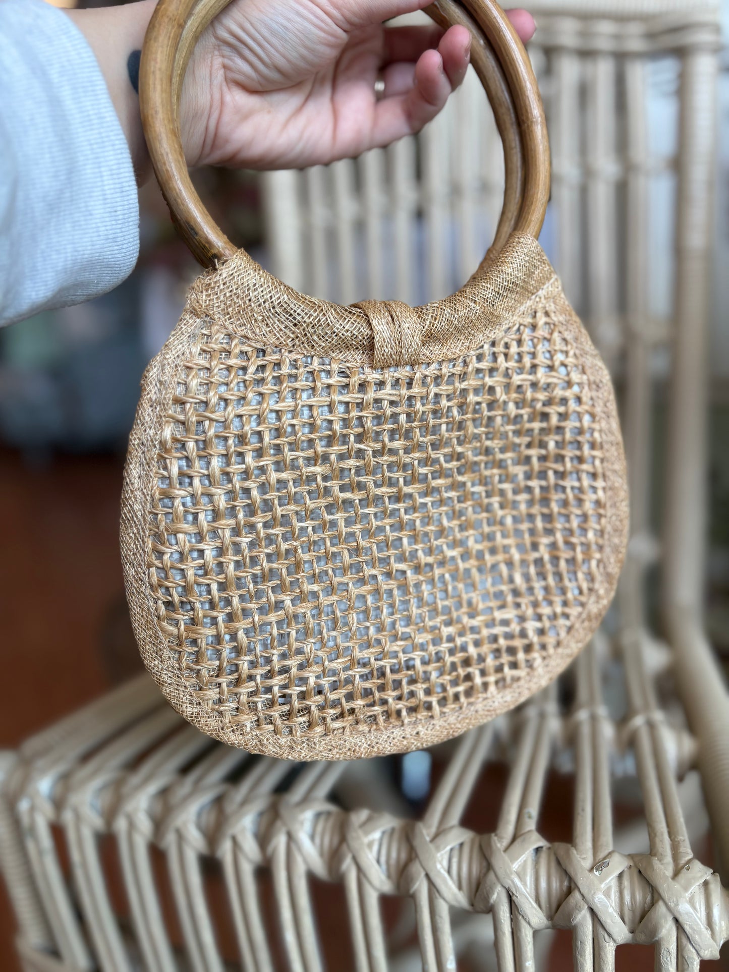 Small woven handbag with bamboo handles