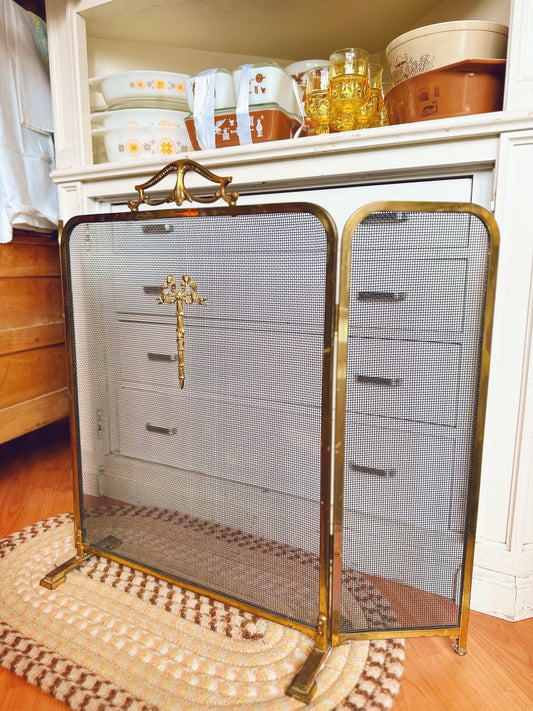 Folding brass fireplace screen with bow detail