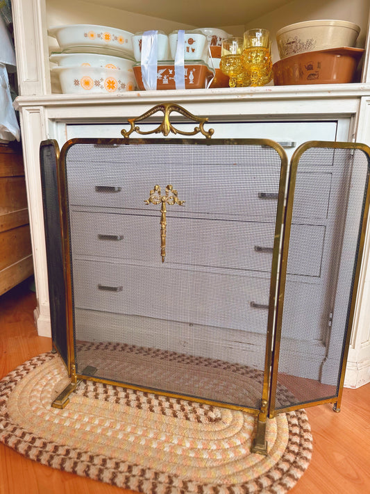 Folding brass fireplace screen with bow detail
