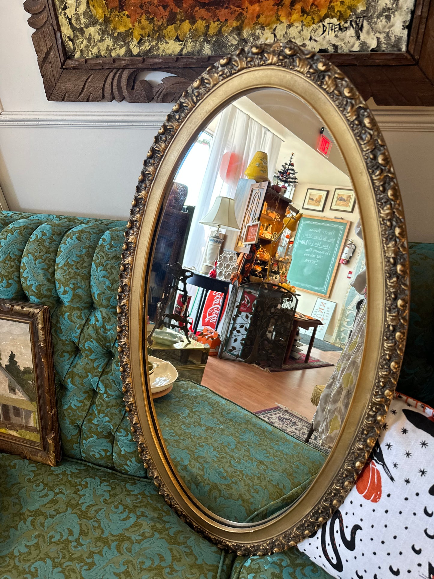 Oval mirror with intricate gold frame