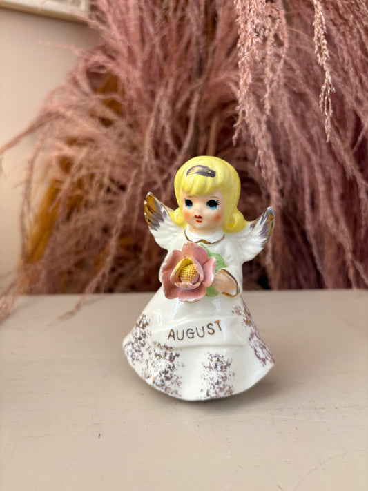 August Angel Figure holding pink flower