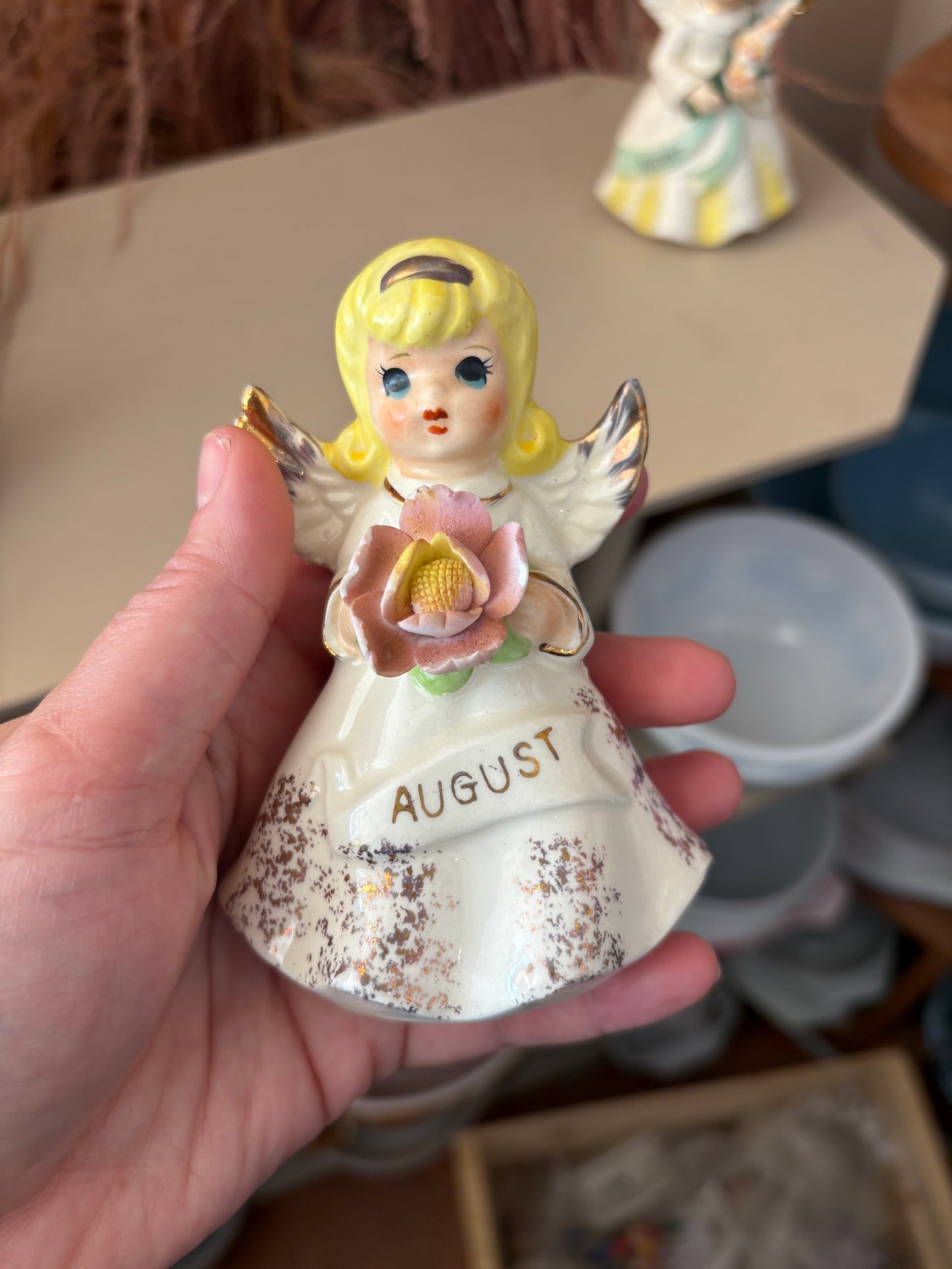 August Angel Figure holding pink flower