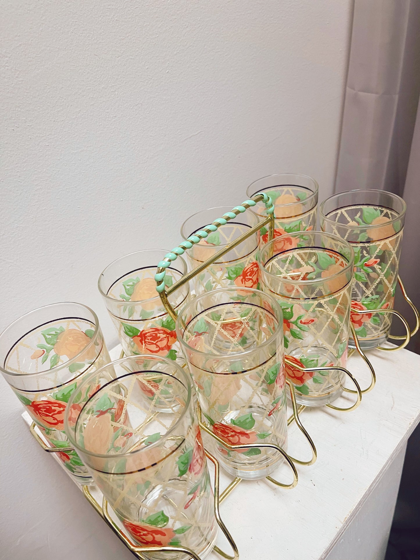 8 Rose pattern glasses in metal caddy