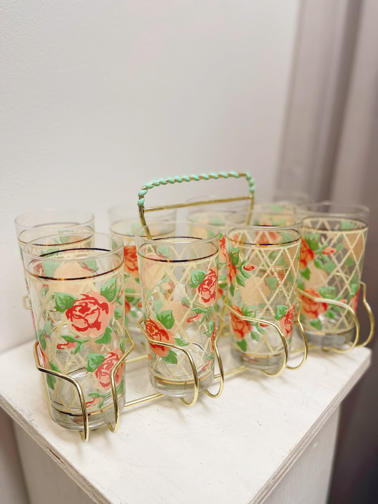 8 Rose pattern glasses in metal caddy