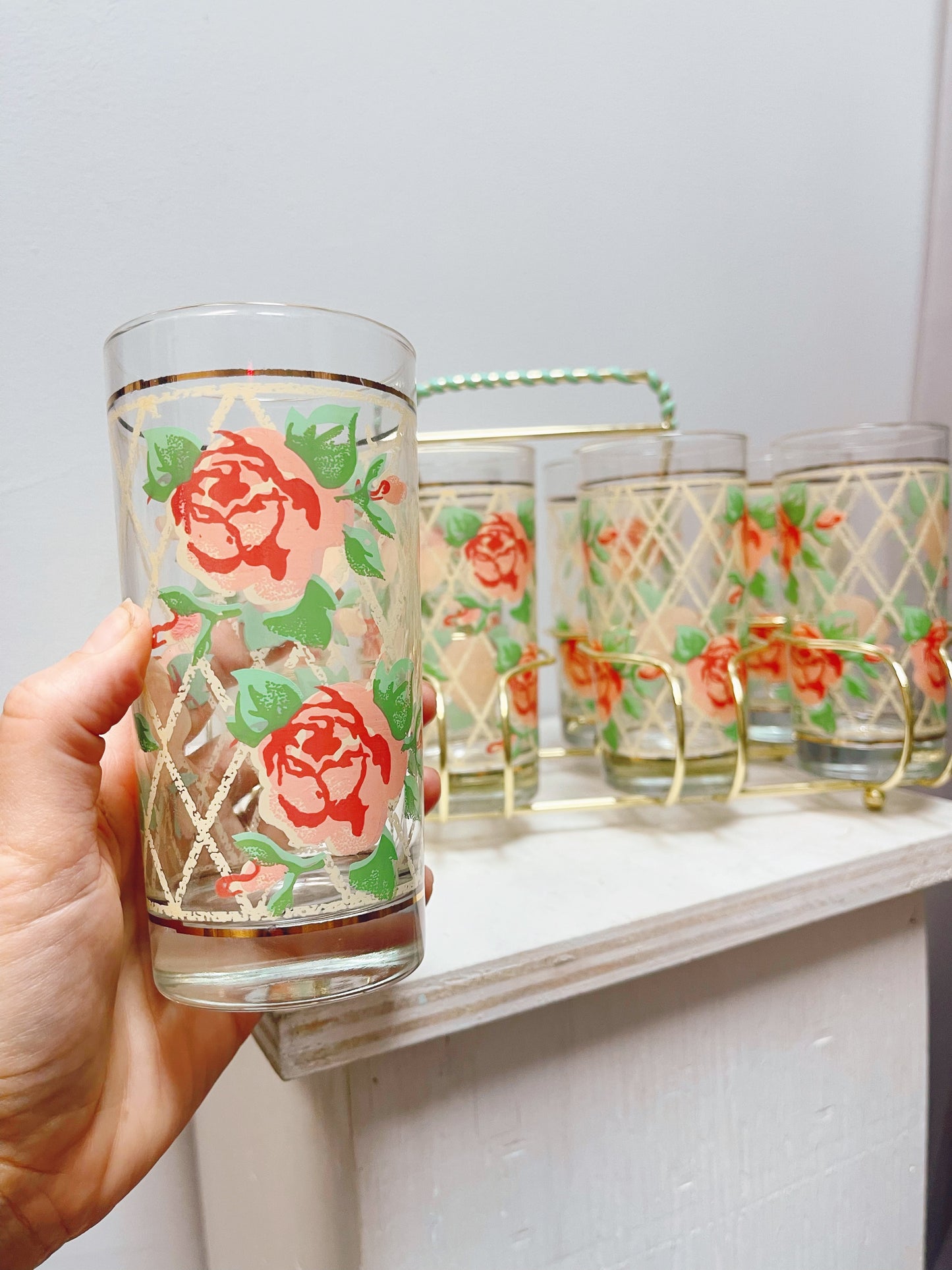 8 Rose pattern glasses in metal caddy